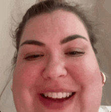 a close up of a woman 's face with her eyes closed and her mouth open .