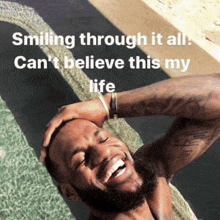 a man is smiling in a pool with the words smiling through it all can 't believe this my life