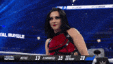 a woman with blue hair is standing in a wrestling ring with the words royal rumble in the background