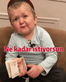 a child is holding a stack of money with the words ne kadar istiyorsun written on the bottom