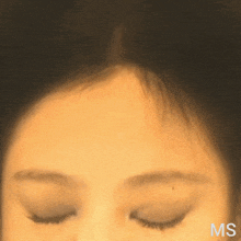a close up of a woman 's face with the letters ms below her