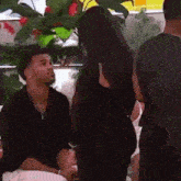 a man and a woman are sitting next to each other in a room talking to each other .