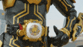 a person wearing a black and gold costume has a belt with a clock on it