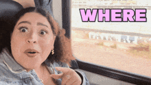 a woman sitting on a train with the word where above her head