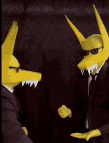 a man in a suit and tie stands next to another man in a yellow mask