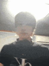 a blurry picture of a person wearing a black shirt with the letters ck on it