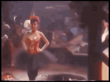 a man and a woman are dancing in a dark room .