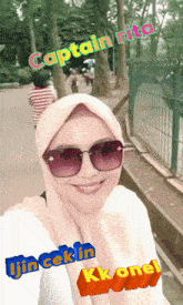 a woman wearing sunglasses and a hijab with the name captain rita written on her face