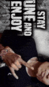 a man laying down with the words " stay one and enjoy " above him