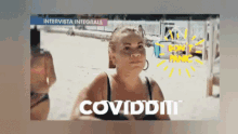 a woman in a bikini stands on a beach with the words coviddit written on the bottom