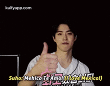 a man in a white shirt is reaching out his hand and saying `` suho : merico te amo ! ''