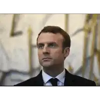 a man in a suit and tie looks to his left