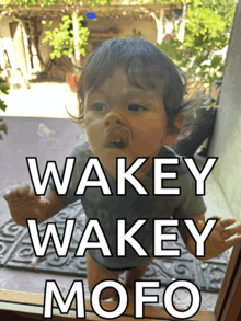 a baby looking out a window with the words wakey wakey mofo written on the bottom