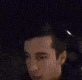 a blurry picture of a man sitting in a car with his arms outstretched