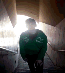 a person wearing a green jacket that says duf
