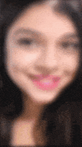 a close up of a woman 's face with pink lipstick
