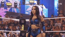 a woman in a wrestling ring with the letter w on the corner