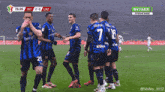 a group of soccer players are standing on a field and one of them has the number 20 on his shirt