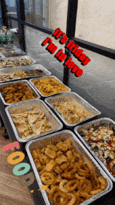 several trays of food on a table with the words it 's friday i 'm in love