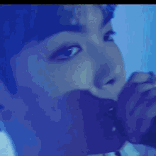 a close up of a person 's face with a microphone in their mouth .