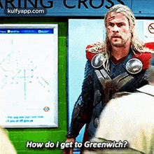 a man in a superhero costume is standing in front of a sign that says how do i get to greenwich .