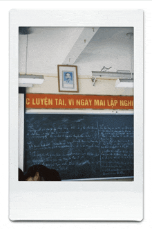 a classroom with a red banner that says c huyen tai vi ngay mai lap nghi