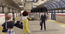 a man in a suit and tie is standing next to a woman in a yellow jacket at a subway station .