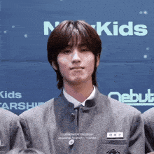 a boy with a name tag that says ' for newkids taegeoin '
