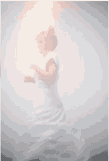 a blurry picture of a woman in a white dress