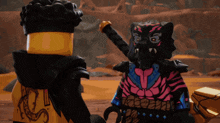two lego figures are standing next to each other and one has a sword in his hand