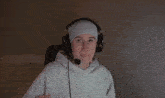 a man wearing headphones and a headband is reaching out with his hand