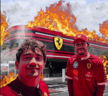 two men standing in front of a ferrari building with flames behind them