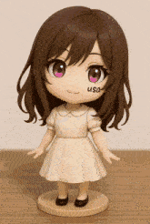 a figurine of a girl with the word usa on her face