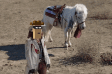 a pixel art of a man standing next to a horse