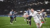 a soccer player with the number 50 on his jersey is celebrating