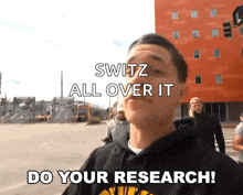 a man in a black hoodie says " do your research "
