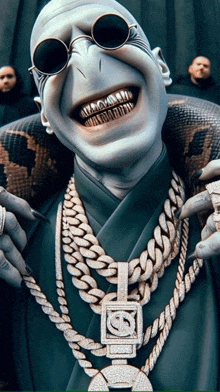 a man wearing sunglasses and a necklace with a pendant that has the letter s on it