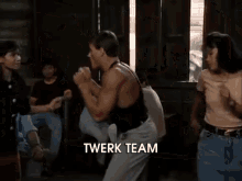 a group of people are dancing and the word twerk team is visible in the corner