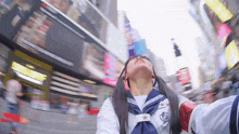 a girl in a sailor uniform is taking a picture of herself