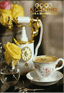 a cup of coffee sits on a saucer next to a telephone and a vase of flowers