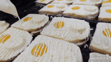 a bunch of eggs on toast with mayonnaise being poured on top