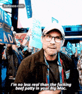 a man is holding a sign that says i 'm no less real than the fucking beef patty in your big mac