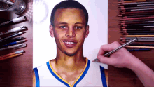 a person is drawing a picture of a basketball player on a piece of paper with colored pencils