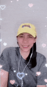 a woman wearing a yellow lakers hat is smiling