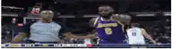a basketball player wearing a lakers jersey shakes hands with an umpire