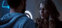 a man and a woman are standing next to each other in a dark room .