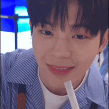 a close up of a young man drinking from a straw