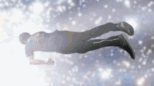 a man is flying through the air in a galaxy while doing a plank .