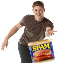 a man is holding a can of spam with a sandwich on it