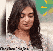a close up of a woman 's face with the words globaltamilchat.com written on the bottom